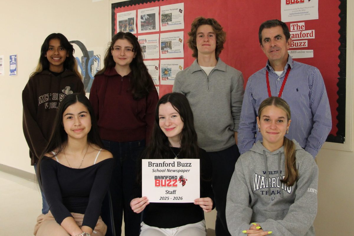 Some of the staff members of The Branford Buzz pose for a group shot during a meeting in November.