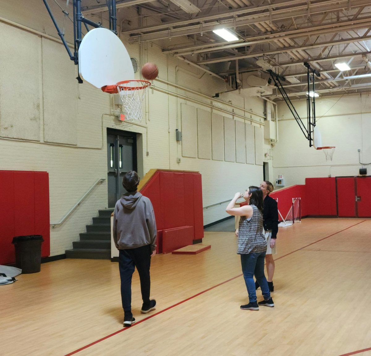 Players Thomas Sturges and Sofia Bobko are accompanied by coach Jessica Cyr. Sofia sinks a 2 pointer at a recent practice.
