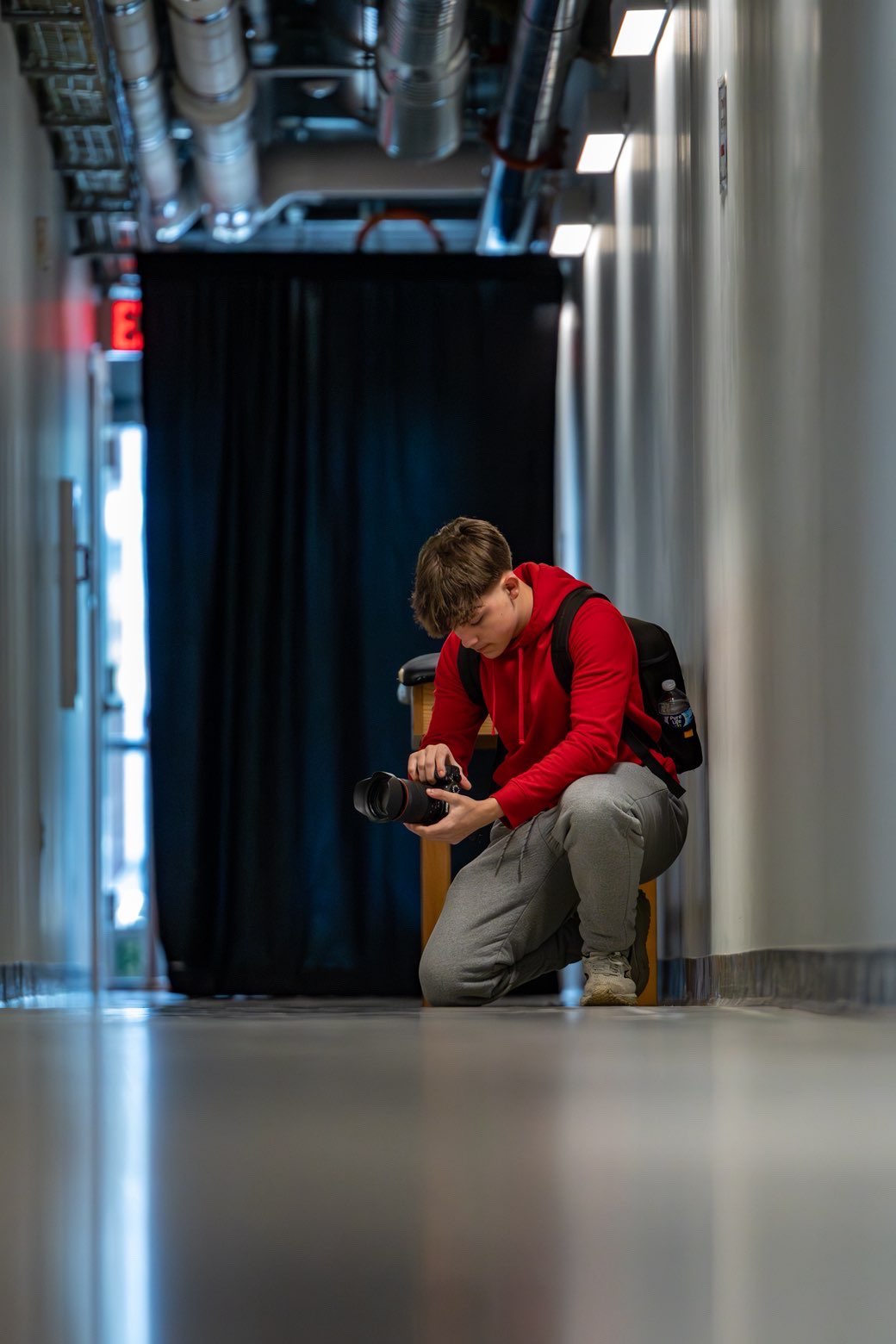 BHS Senior Zander Solano has made his mark taking pictures, mostly of sporting events at the school. Here he checks his settings while photographing Branford's basketball state tournament against Fairfield Prep at Fairfield University's arena.