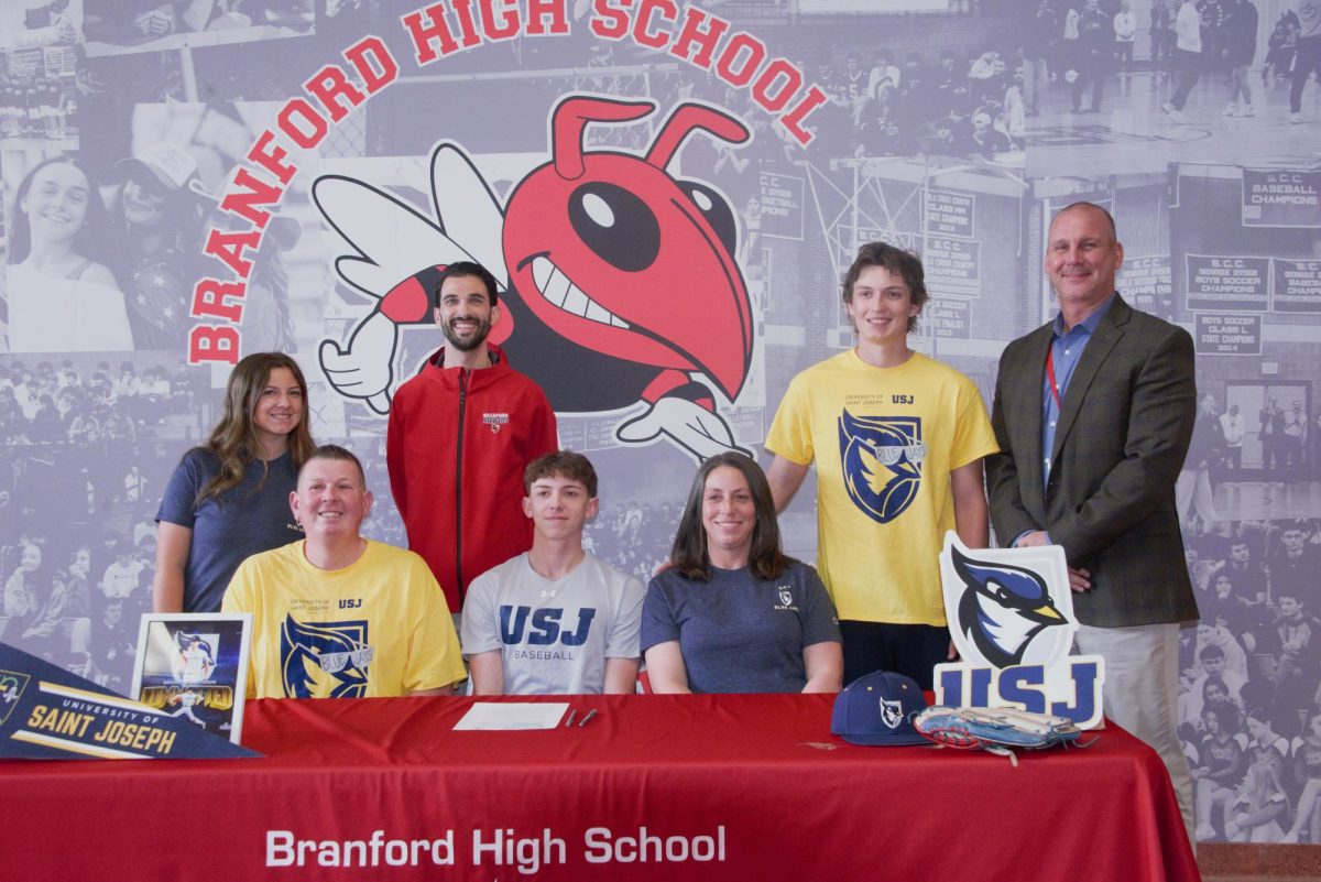 Trevor Cser, center, poses with his family and athletic director Brian Zaklukiewicz, left, and principal Lee Panagoulis, right during the recent signing day at BHS.