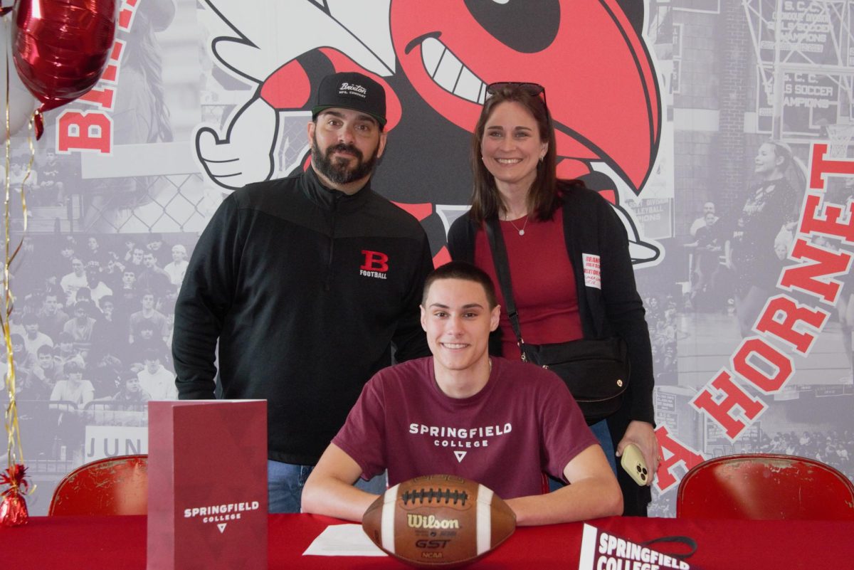Alex Leblanc, center, along with head football coach John Limone and his wife, Laura, at this week's signing ceremony.