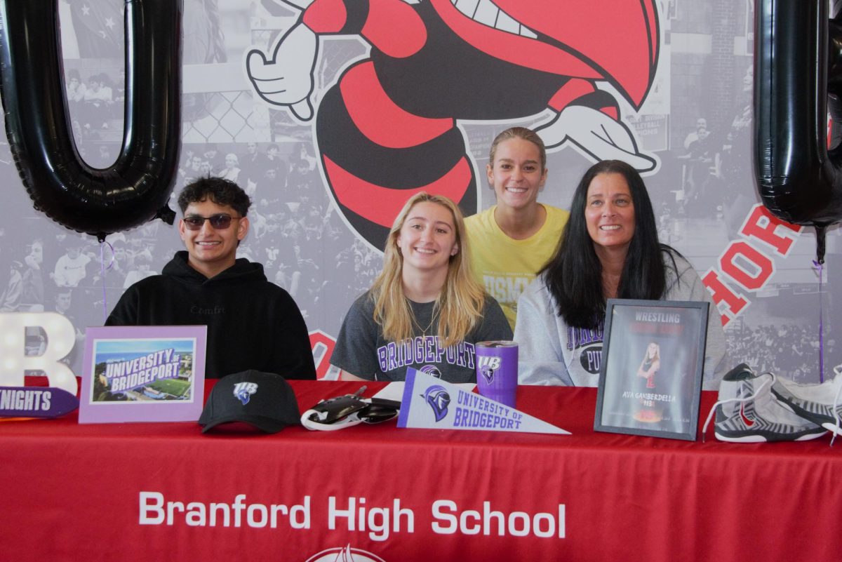 Ava Gamberdella and Caitlyn Lentner pose with family and friends at the recent signing day ceremonies.