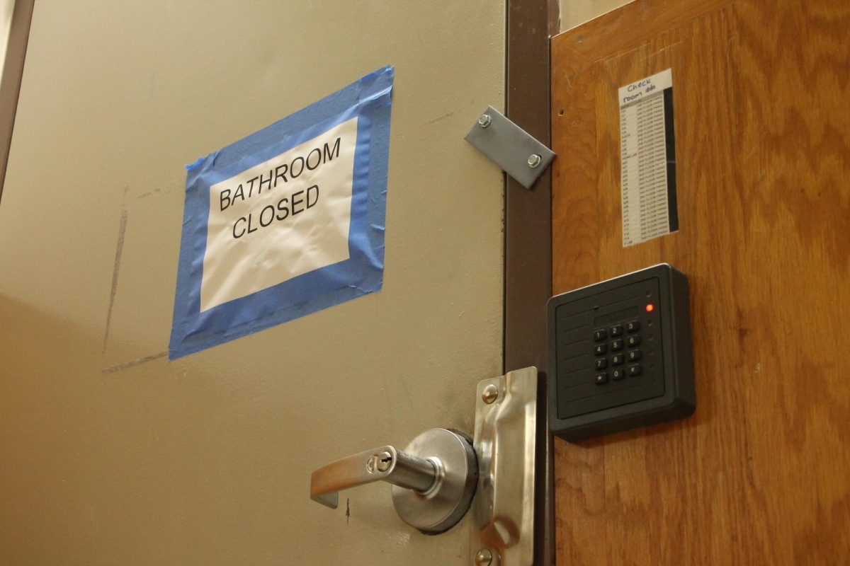 The F-Wing men's bathroom sits bolted shut.